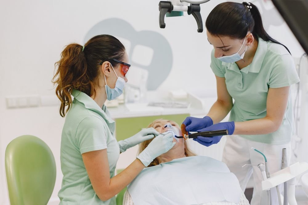 Equipo odontológico realizando una intervención de cirugía oral en la clínica